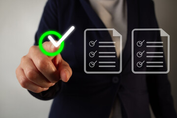 Businesswoman pointing forward at a check mark in a circle while documents with check marks and to-do lists float by.