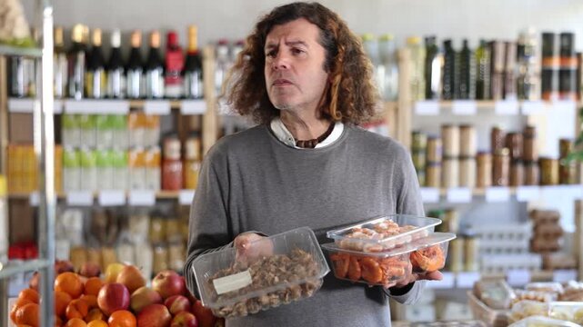 Man choose shrimp and shellfish Bolinus brandaris together for homemade lunch at the supermarket. High quality 4k footage