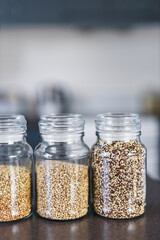 clear pantry jars with different types of grains and legumes including quinoa  lentils buckwheat...