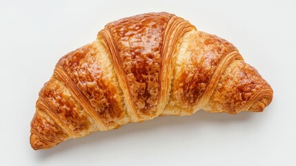 A single croissant with golden brown crust isolated against a plain white surface background view