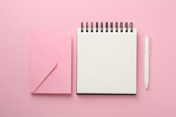 Notebooks and pens on pink background, flat lay