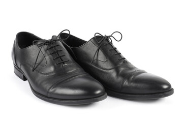 Pair of black leather shoes on white background