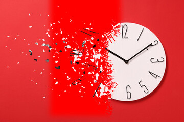 Time running out. Clock dissolving on red background