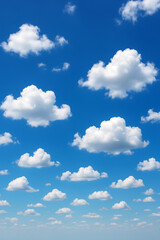 Fototapeta premium A clear blue sky dotted with fluffy white clouds. The scene evokes a sense of peace, openness, and natural beauty.