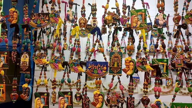 A vendor has arranged various types of locally made necklaces & ornaments made of wood, bamboo, and plastic for the exhibition and sale at the art fair in Asansol, West Bengal, India