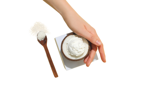 Hand scooping creamy dessert in a bowl with spoon, isolated on white, PNG