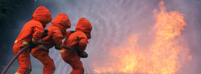 Banner Firefighter Rescue training fire fighting extinguisher. Firefighter fighting flame using...