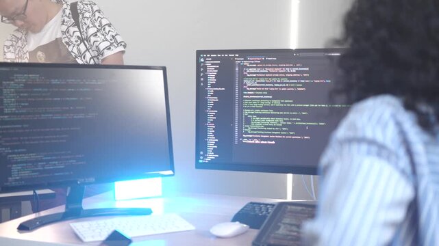 A dedicated IT team collaborates in a command center, working on a critical software deployment or incident response. Concept for system implementation, teamwork, and operations.