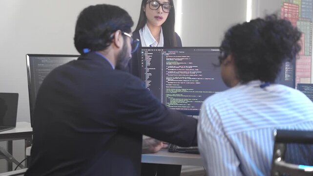 A senior software engineer leads a code review session, mentoring his diverse team on a complex project. Concept for agile development, knowledge transfer, and teamwork.
