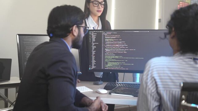 A senior software engineer leads a code review session, mentoring his diverse team on a complex project. Concept for agile development, knowledge transfer, and teamwork.