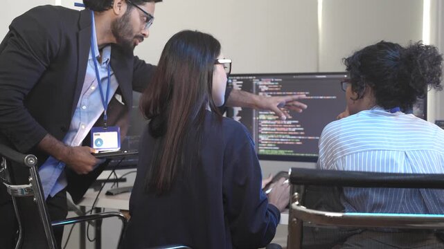 A dedicated IT team collaborates in a command center, working on a critical software deployment or incident response. Concept for system implementation, teamwork, and operations.