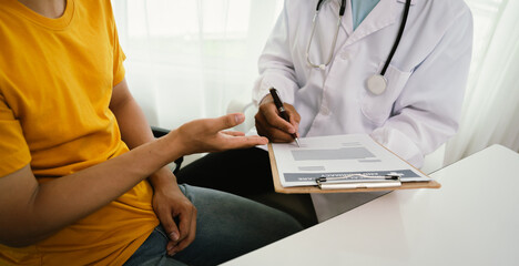 A male patient consults a doctor during a medical exam focused on prostate or testicular health, discussing symptoms, diagnosis, and treatment options with trust and professional care.