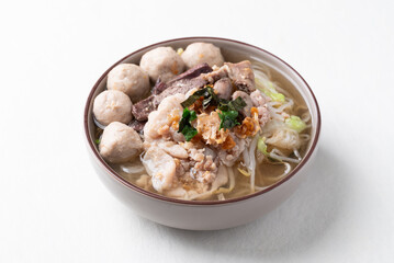 Thai noodles soup with sliced pork, minced pork, meatball and liver in a bowl on white background, Traditional Thai street food