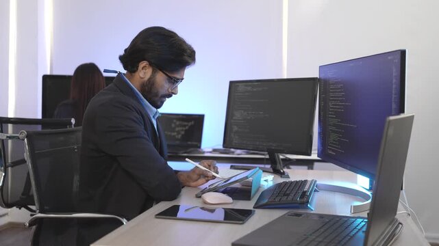 An Indian FinTech engineer engrossed in algorithmic trading platform development at a multi-display rig. Concept for quantitative finance and high-frequency data streams.