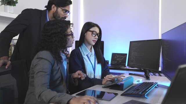 A senior developer mentoring a colleague, pointing at code during a pair programming and debugging session. Concept for teamwork, mentorship, and agile software developm