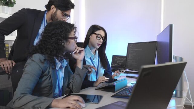 A dedicated IT team collaborates in a command center, working on a critical software deployment or incident response. Concept for system implementation, teamwork, and operations.