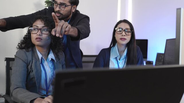 A senior developer mentoring a colleague, pointing at code during a pair programming and debugging session. Concept for teamwork, mentorship, and agile software developm