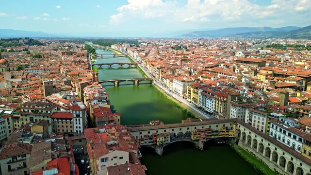 The Arno River and the Italian city of Florence on both banks of the river. 4K, high quality.