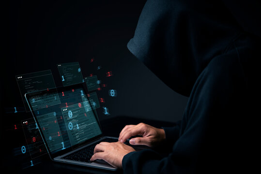 Cybersecurity hacker in dark hoodie with laptop and virtual data. Cybercrime concept of illegal anonymous internet criminal activity and privacy breach, system network technology.