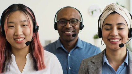 A team of diverse and friendly support agents with headsets smiles confidently at the camera. - Powered by Adobe