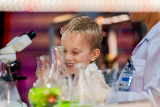 A young scientist and a child conducting an experiment in a laboratory. Encouraging curiosity, STEM education, and hands-on learning in science, chemistry, and biology for future innovation.