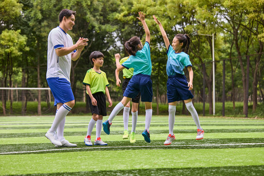 Coach and Kids in Football Training Class