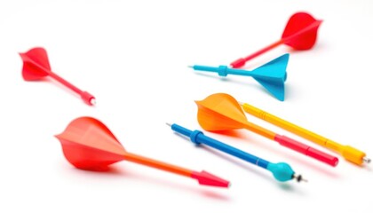Vibrant colorful dart pens scattered on a pristine white background