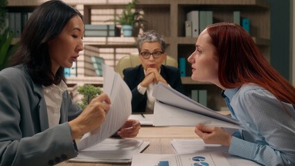 Obraz premium Team multinational women females office businesswomen business financial crisis problem misunderstanding co-workers partners arguing conflict documents discuss talking employees papers indoor briefing