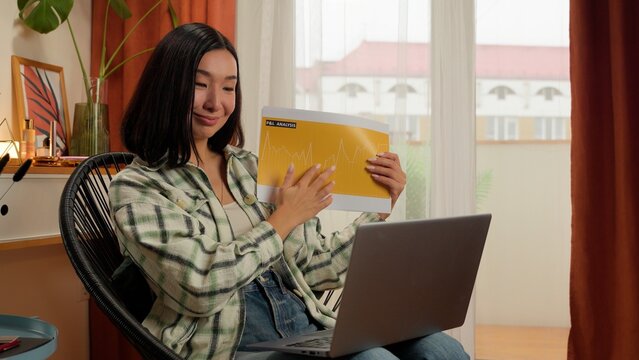Asian Japanese business woman businesswoman using laptop female home Chinese Korean girl waving hand designer showing chart graph profit indoor computer entrepreneur online meet conference with client