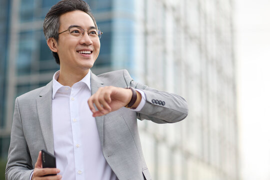 Mature businessman checking the time