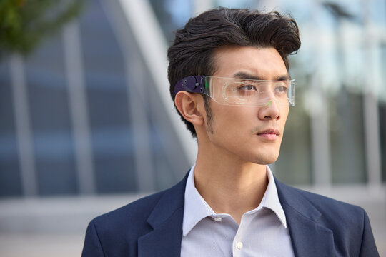 Young businessman wearing smart glasses