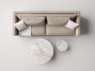 Overhead view of a beige fabric sofa with two pillows and a throw, accompanied by a large and a small round marble-topped side table on a light gray floor