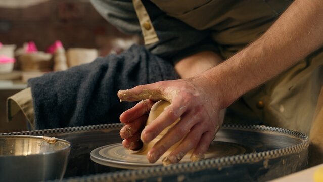 Master potter in studio male craftsman sculpting vase jug clay art unrecognizable man human hands guy sculptor process modeling handmade pottery workshop professional artist hobby ceramics handcraft - Powered by Adobe