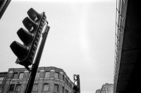 Fototapeta Vintage analog photography of traffic lights and urban buildings in monochrome
