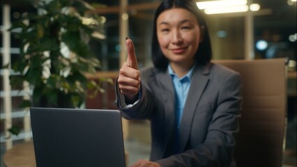 Asian Korean Chinese Japanese businesswoman typing using laptop computer online business woman female girl lady in office worker showing gesture thumb up approve good manager employer recommend like
