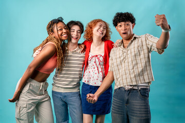 Obraz premium Portrait of diverse Generation Z friends posing on isolated blue screen.
