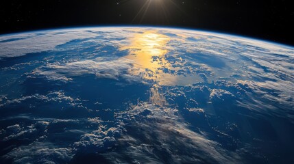 The Earth's surface, with the sun shining brightly above the horizon, casting a warm glow over the planet's blue and green hues.