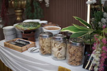 Glass Jars of Indonesian Crackers on Buffet Table