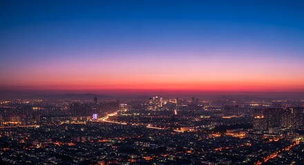 Cityscape at twilight with vibrant sunset colors over urban skyline during nightfall