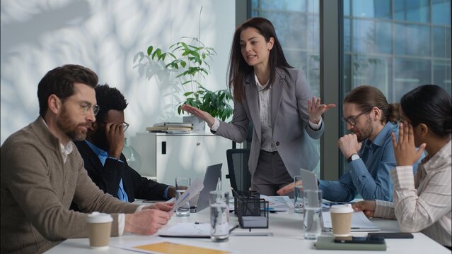 Caucasian woman leader arguing shout stress financial problem trouble documents bad work result boss angry talk dissatisfied team in office businesspeople business diversity multinational women men