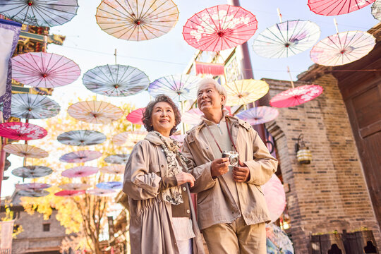 Senior couple enjoying a peaceful visit to a man-made historic town scenic site - Powered by Adobe