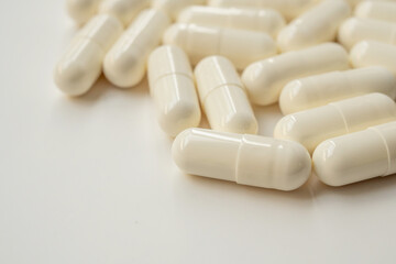 White medicine pills capsule on white background