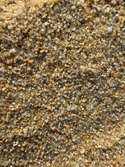 Background of golden beige sand with big rough texture with natural pattern under the sunlight