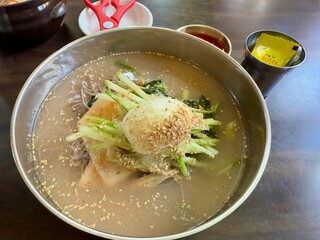 Mul makguksu, Korean traditional cold buckwheat noodles on a bowl on the table. The specialty food of Gangwon-do area