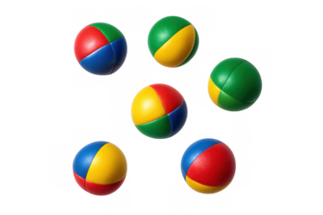 Multicolored juggling balls suspended against translucent surface, highlighting performance skill and playful entertainment concept