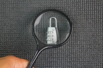 Magnifying glass and lock or find cyber protection. Computer security concept. Concept of inspect...