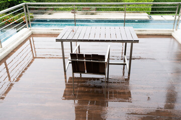 Old wood chair and table on balcony after raining