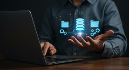 A person's open palm holds a glowing data illustration. A laptop sits beside them, suggesting technological focus