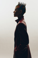 Profile of a woman with colorful braided hair and a spiked crown, wearing a dark leather jacket...
