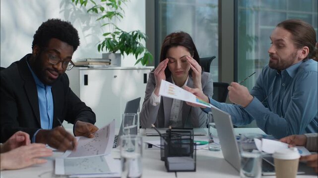 Stressed unhealthy Caucasian team leader businesswoman holding head ache headache pain suffering medicine multiethnic colleagues diversity business people arguing conflict shouting yelling in office